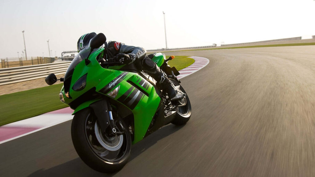 Thrilling Green Motorcycle Race Track Wallpaper Background