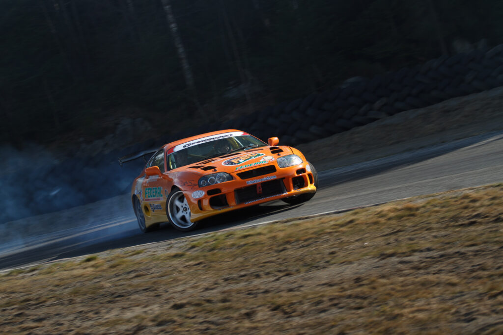 Dynamic Wallpaper: Orange Toyota Supra Drifting with Speed & Power