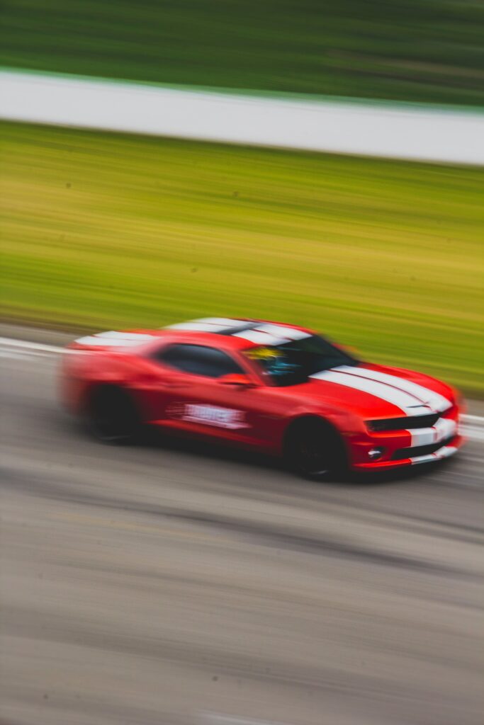 Red Sports Car Racing Wallpaper with Motion Blur Background