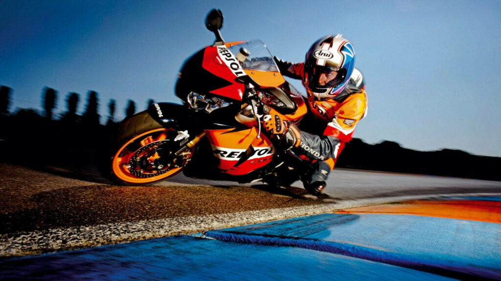 Dynamic Biker on Repsol Motorcycle at Dusk - Thrilling Wallpaper