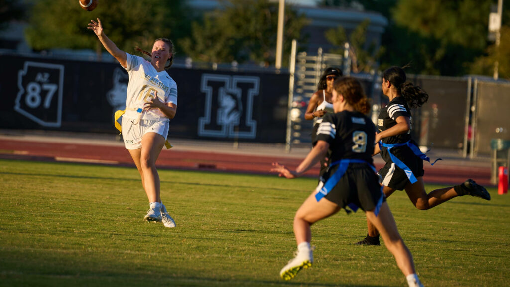 “Dynamic Wallpaper: Intense Girls' Flag Football Action & Teamwork”