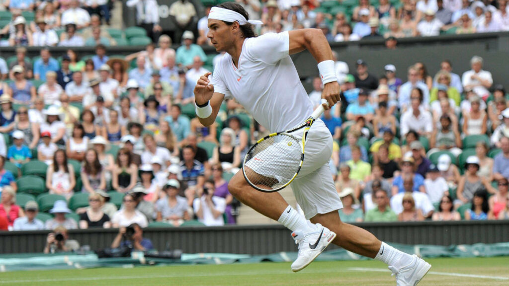 Rafael Nadal in Action: Dynamic Tennis Wallpaper Background