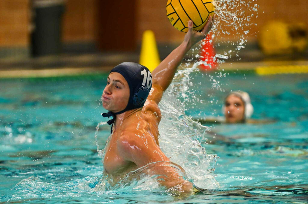 Dynamic Water Polo Action: Athlete Mid-Game Wallpaper Background