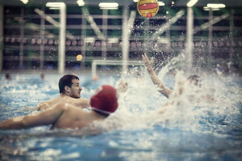 Dynamic Water Polo Wallpaper: Players in Action with Splashing Water