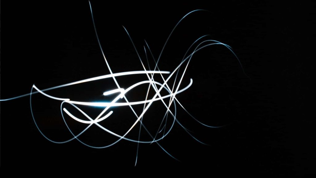 Dynamic white light trails on black background for neon minimalist desktop wallpaper background