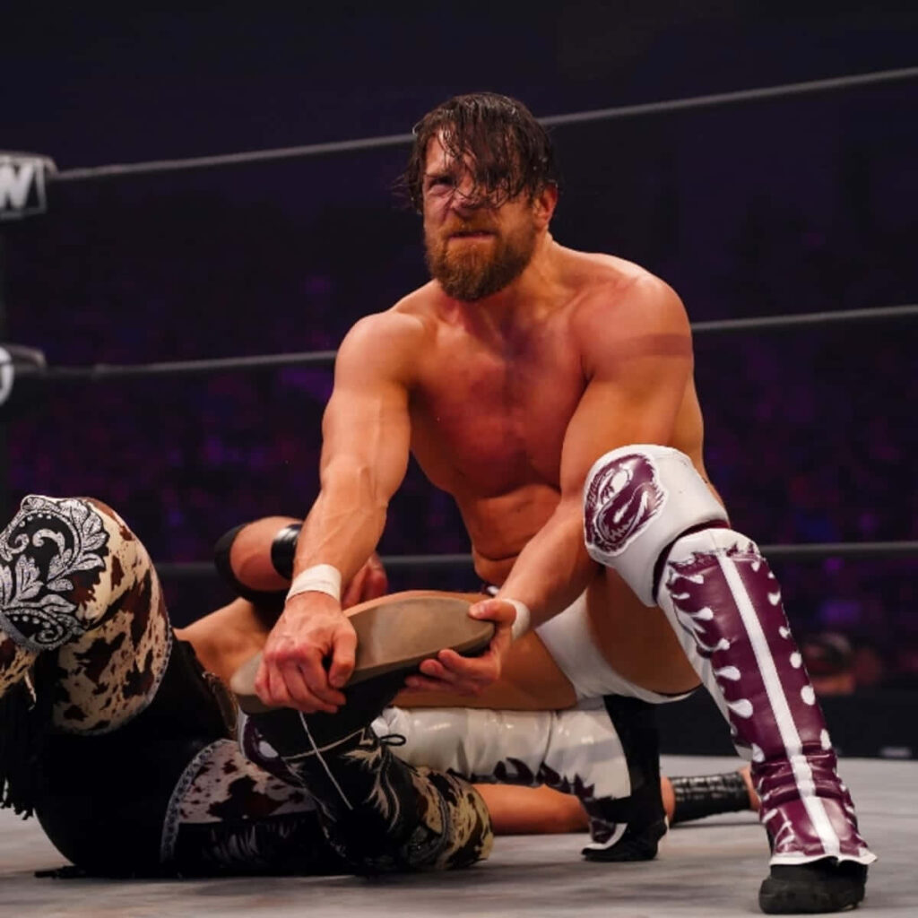 Bryan Danielson intense wrestling action inside ring vivid lighting dynamic sports wallpaper
