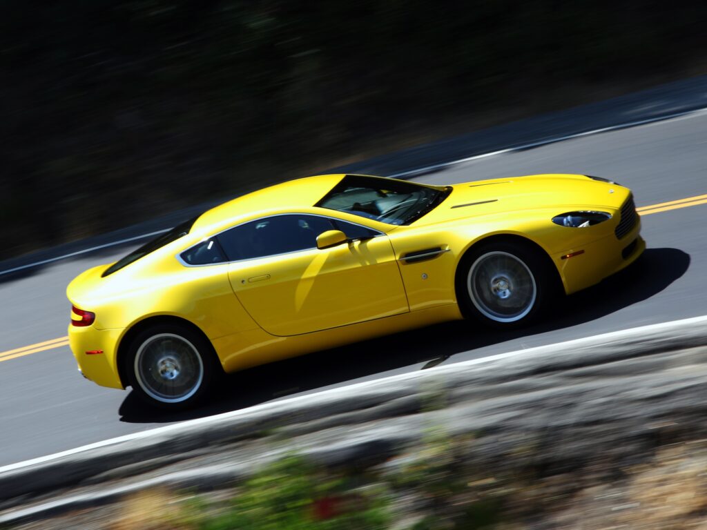 Dynamic Yellow 2008 Aston Martin V8 Vantage Wallpaper - Sleek Elegance