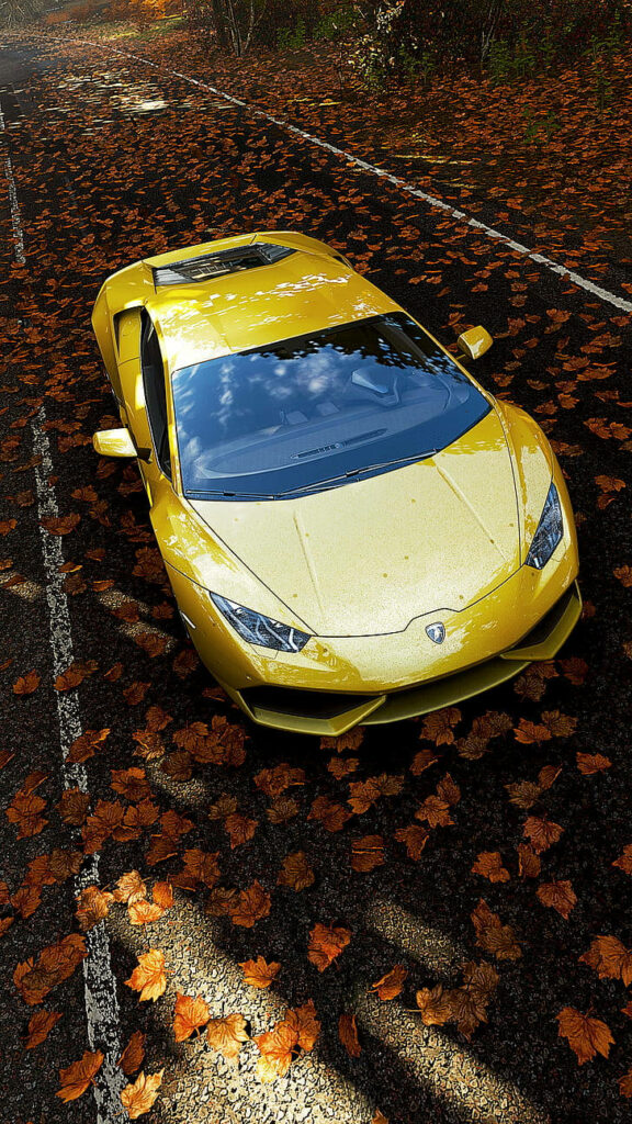 Dynamic Yellow Lamborghini Wallpaper with Autumn Leaves Background