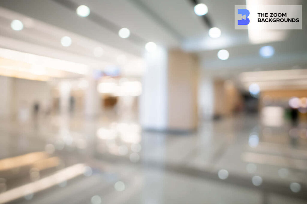 Blurred modern office corridor with warm bokeh lighting perfect for professional video calls background Wallpaper