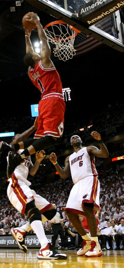 Dynamic iPhone Wallpaper: Basketball Star Rose's Impressive Dunk