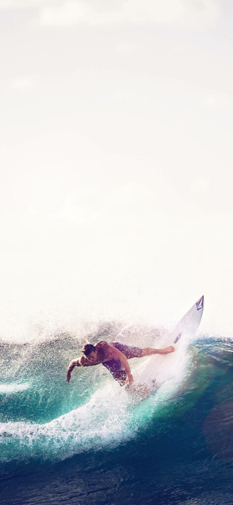 Adventure iPhone Wallpaper: Surfer Riding Waves on White Surfboard