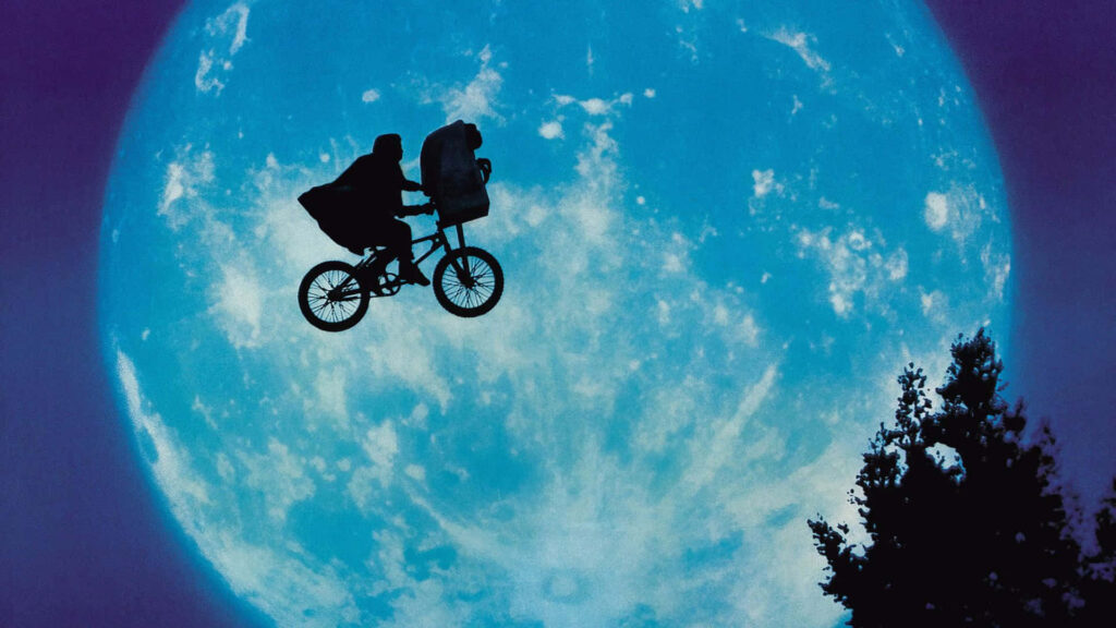 Nostalgic E.T. Bike Ride Wallpaper: Boy & Alien Under Moonlit Sky