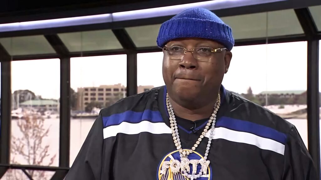 E-40 in vibrant blue knit hat gold chain urban street style hip-hop culture wallpaper background