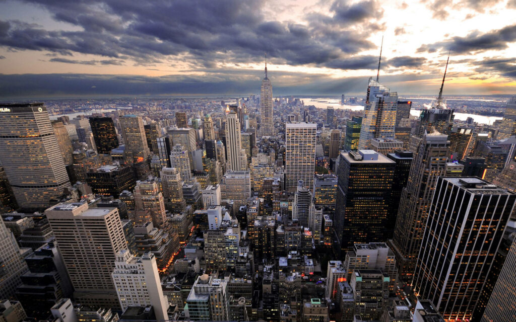 Dawn Illuminates Manhattan: A Captivating Snapshot of Morning Light Embracing City Skyscrapers Wallpaper