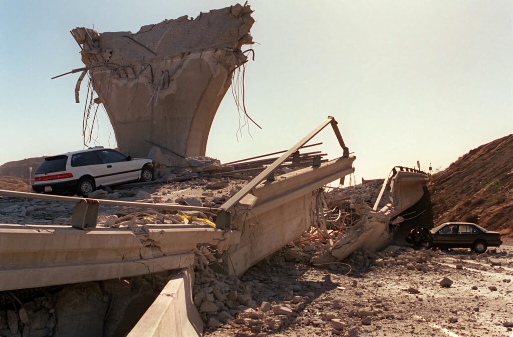 Collapsed concrete bridge and debris after earthquake showing destruction and resilience wallpaper