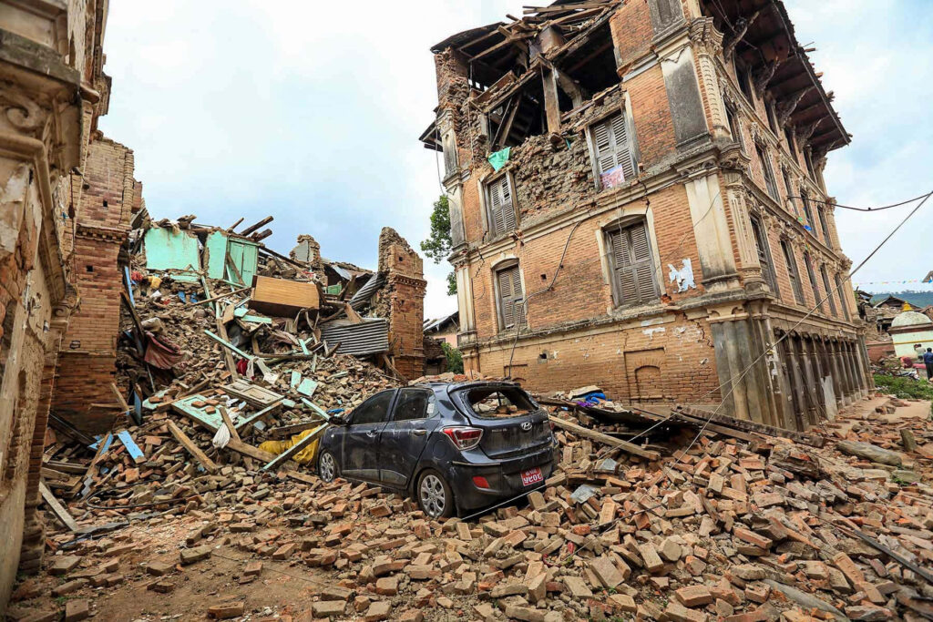 Earthquake aftermath with collapsed buildings rubble damaged car showing devastation resilience Wallpaper