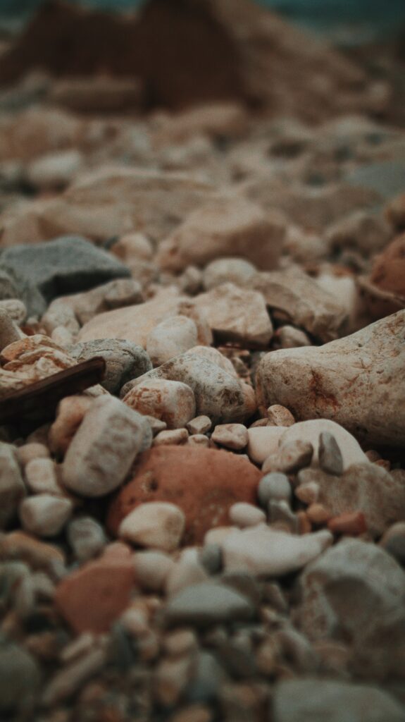 Close-up of natural stones and pebbles wallpaper in earthy tones evoking calm marine shoreline