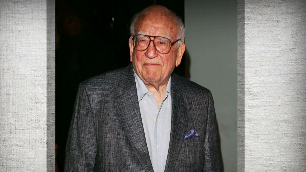 Ed Asner in grey suit blue shirt glasses charismatic warm portrait wallpaper background