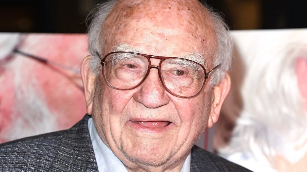 Ed Asner portrait with round glasses warm expression detailed face soft blurred background wallpaper