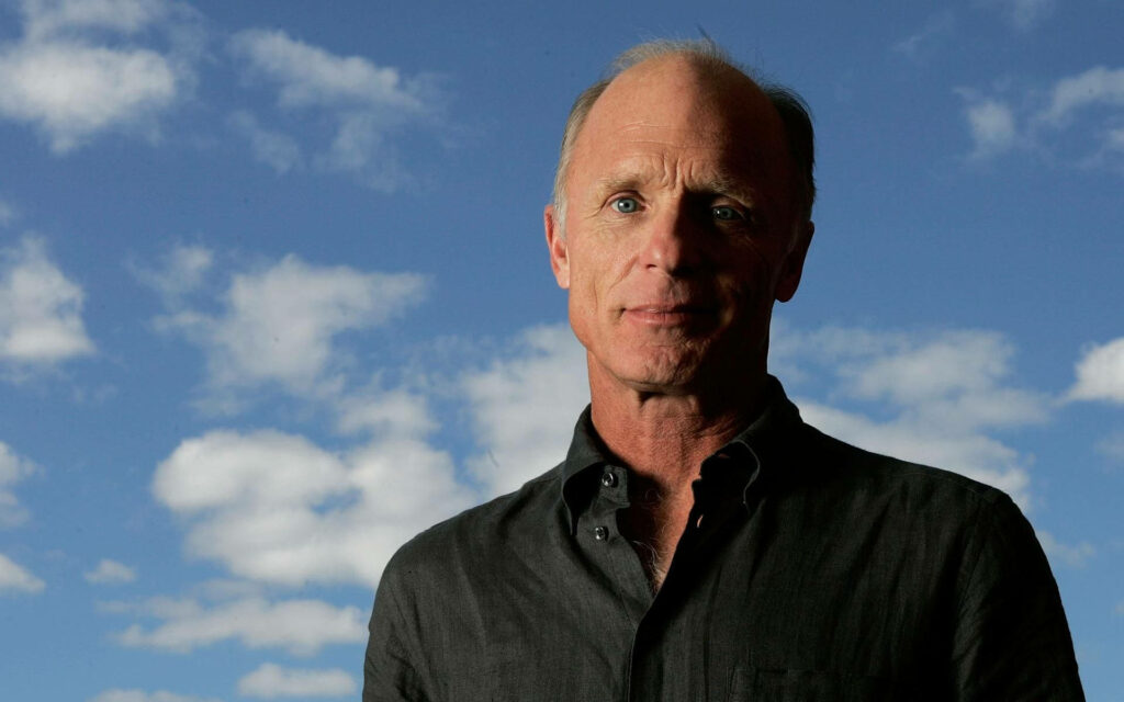 Ed Harris portrait outdoors under blue sky with white clouds natural light calm expression Wallpaper