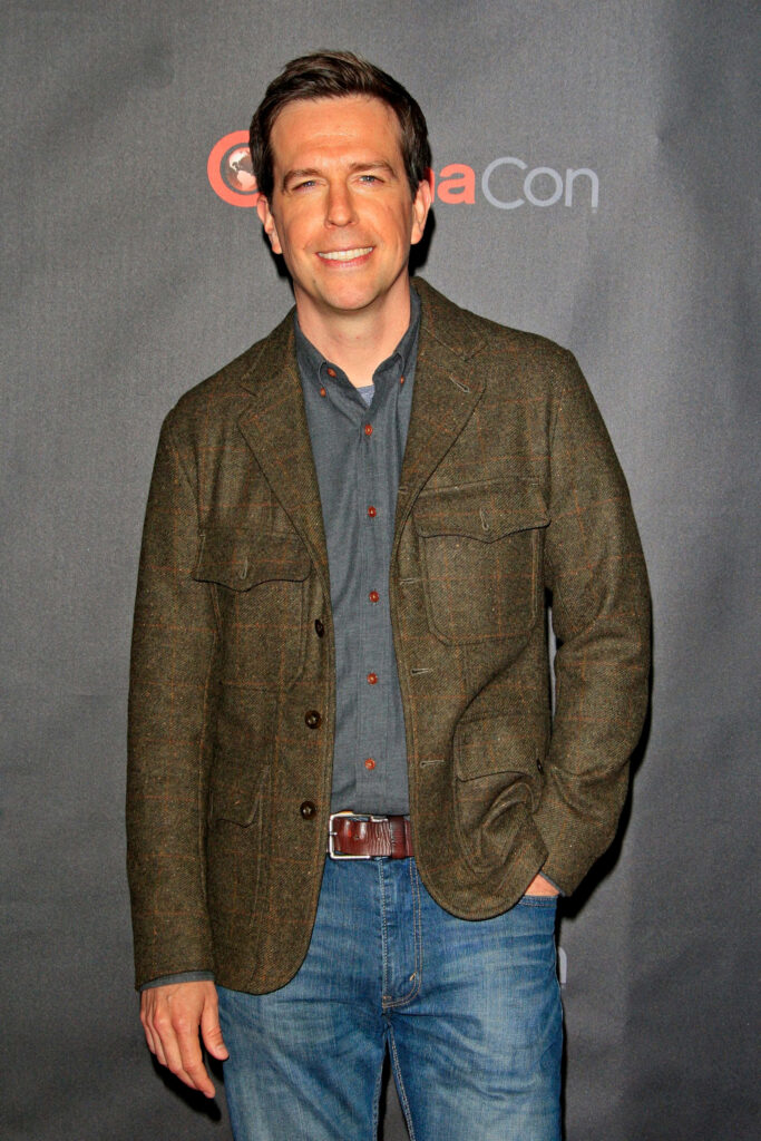 Ed Helms in casual green jacket blue jeans at CinemaCon dark textured backdrop high resolution wallpaper