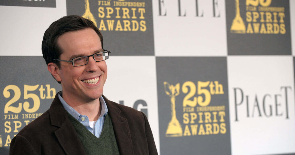 Ed Helms smiling on red carpet at 25th Film Independent Spirit Awards in dark blazer and sweater Wallpaper