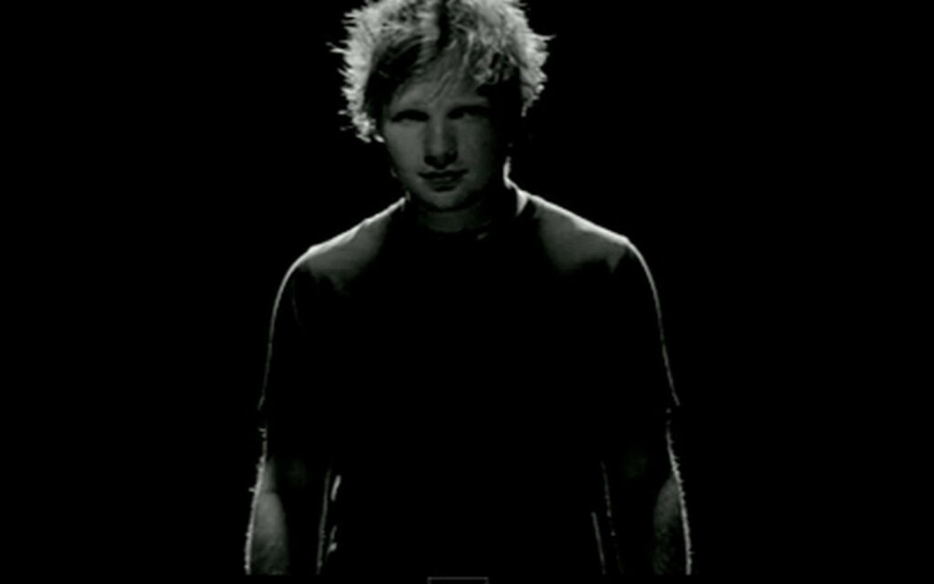 Ed Sheeran Black-and-White Wallpaper: Mysterious Shadowy Background