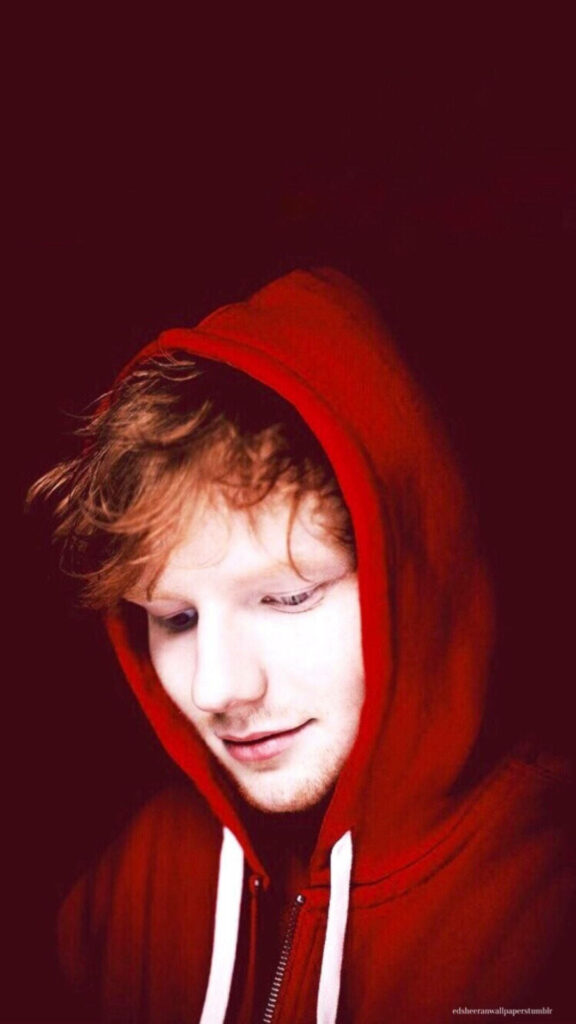 Ed Sheeran Close-Up Wallpaper: Soft Red Hoodie on Dark Background