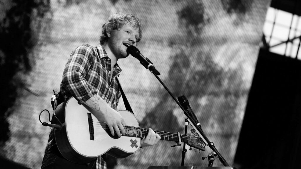 Ed Sheeran Live: Passionate Performance Wallpaper with Guitar