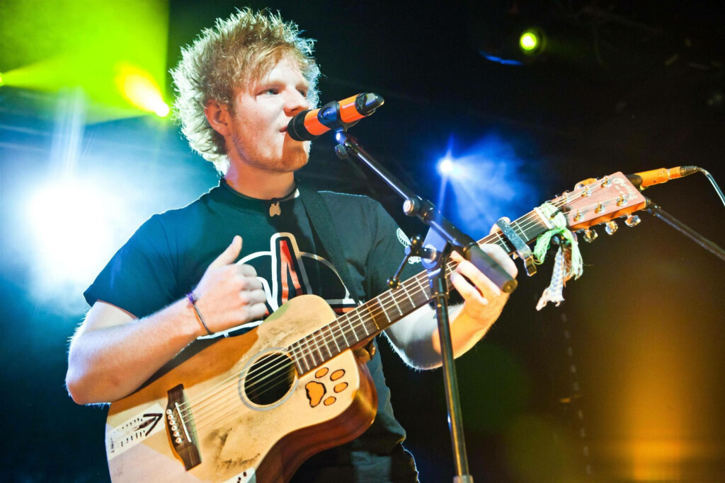 Ed Sheeran Live: Captivating Guitar Performance in Vibrant Wallpaper