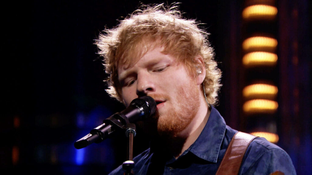 Ed Sheeran's Soulful Performance on Stage - Captivating Wallpaper