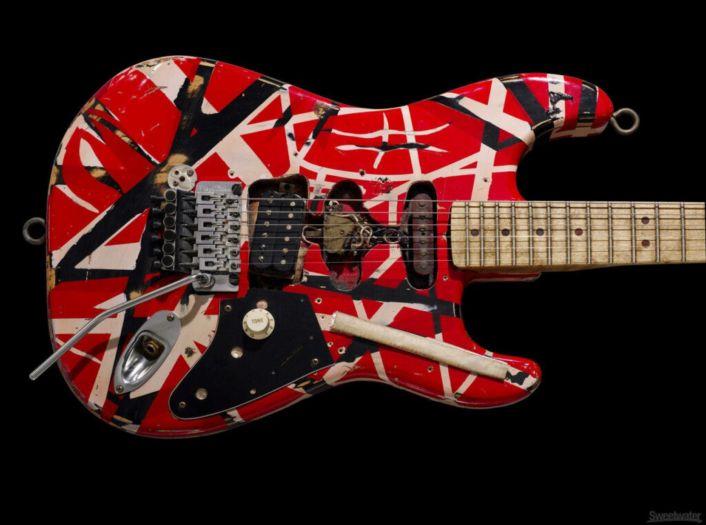 Close-up of Eddie Van Halen signature red guitar with white black stripes and vintage hardware Wallpaper