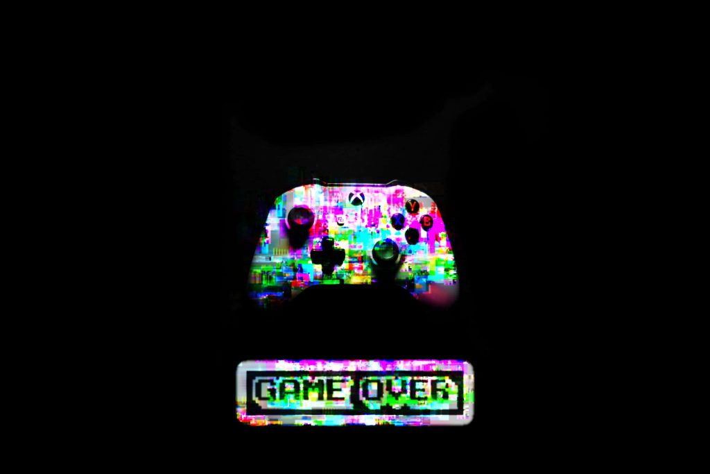 Edgy dark glitch art Xbox controller wallpaper with vibrant static and pixelated game over text