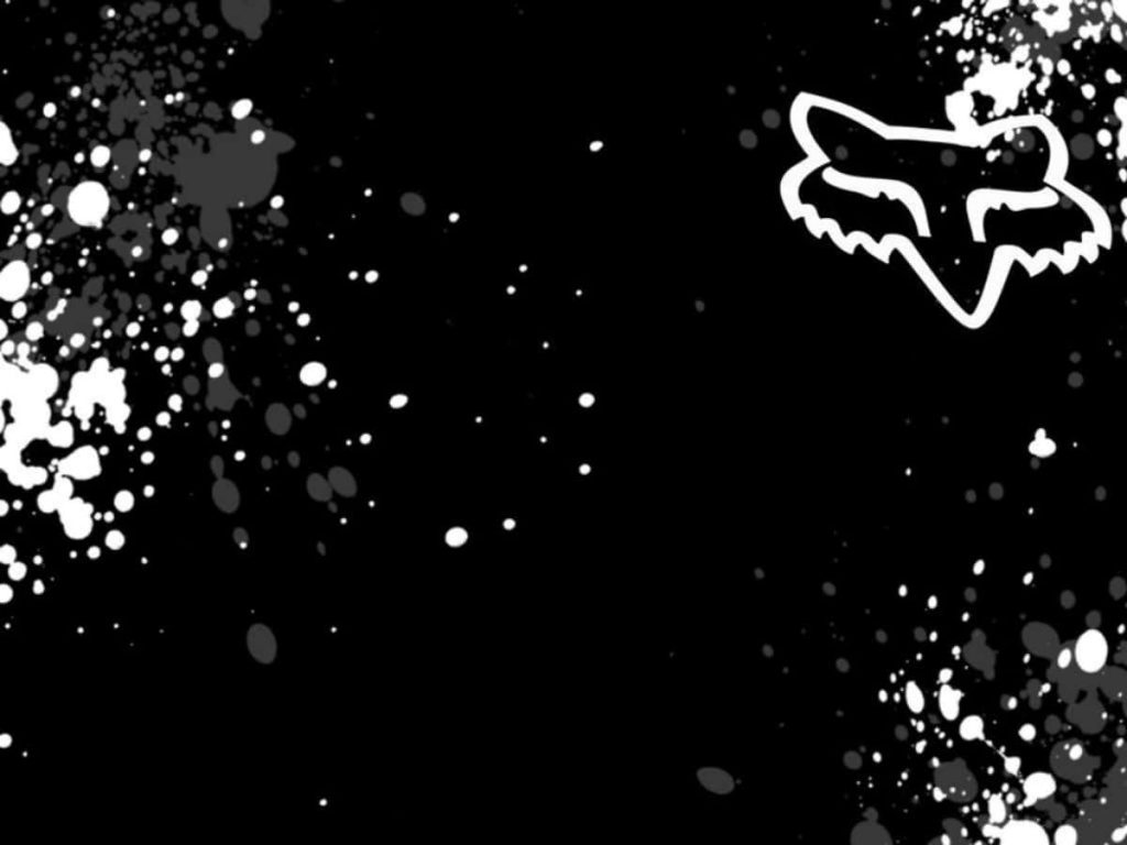 High-contrast Fox Racing wallpaper with white Fox Head logo grunge splatter black background