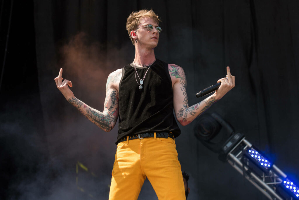 Edgy Machine Gun Kelly Wallpaper: Yellow Pants & Tattoos on Stage