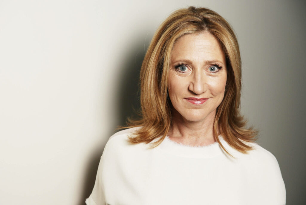 Edie Falco portrait soft lighting gentle expression natural makeup minimalist light background Wallpaper
