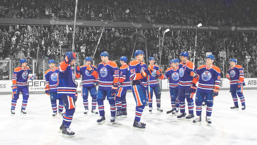 Edmonton Oilers hockey team celebrating on ice rink with vibrant blue and orange jerseys Wallpaper
