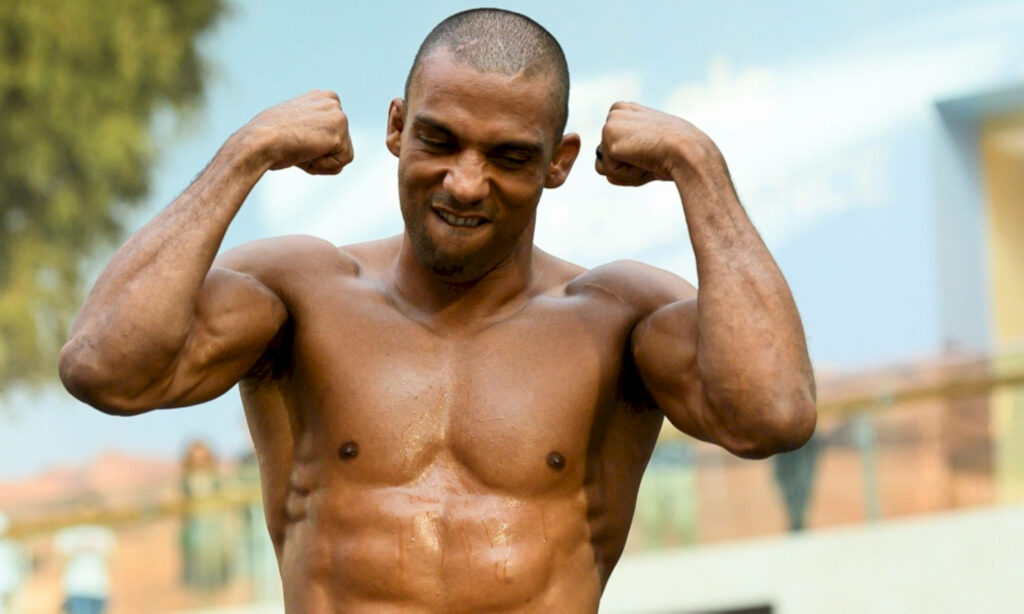 Edson Barboza flexing muscles and gritting teeth showing strength and focus outdoors wallpaper