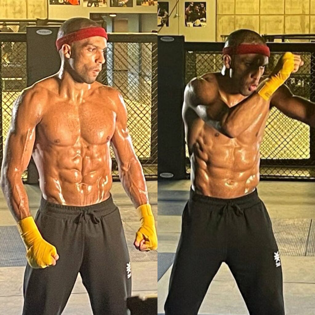 Edson Barboza intense training with yellow hand wraps red headband in gym cage background Wallpaper
