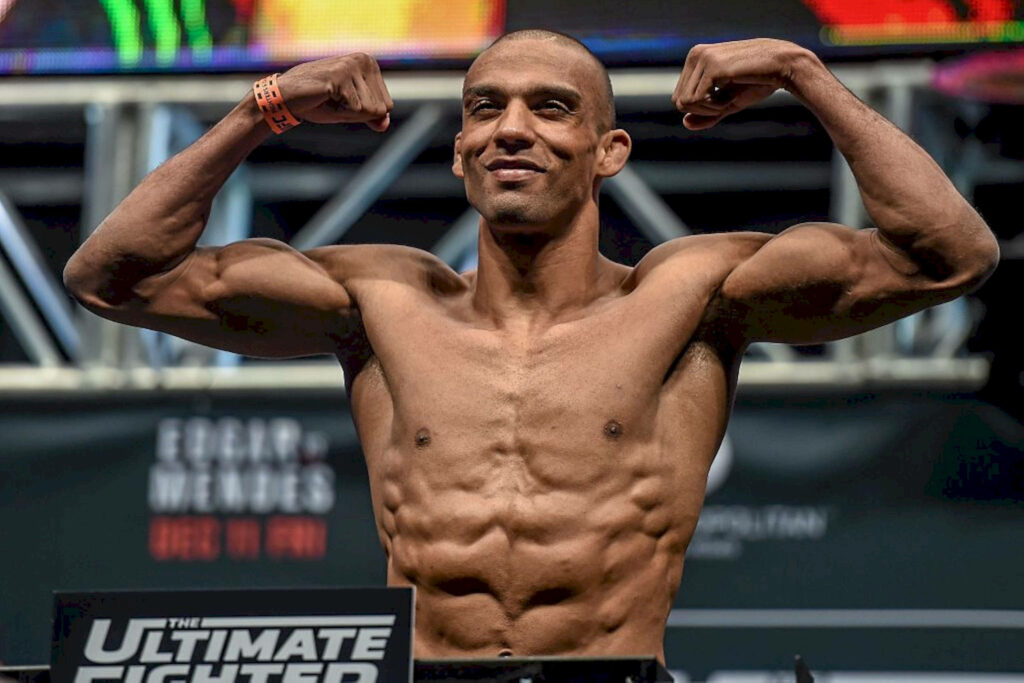 Edson Barboza MMA fighter flexing muscles at weigh-in showing focused intense athletic physique Wallpaper