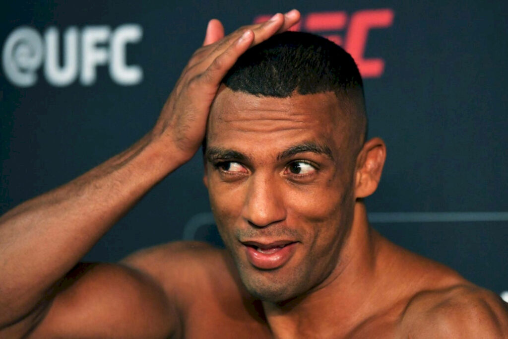 Edson Barboza Brazilian MMA fighter playful pose blurred UFC background athletic build wallpaper