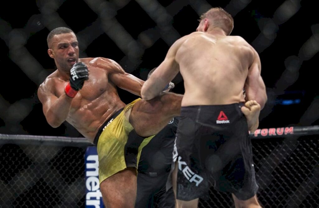 Edson Barboza lands powerful kick on Dan Hooker in intense UFC octagon MMA fight action wallpaper
