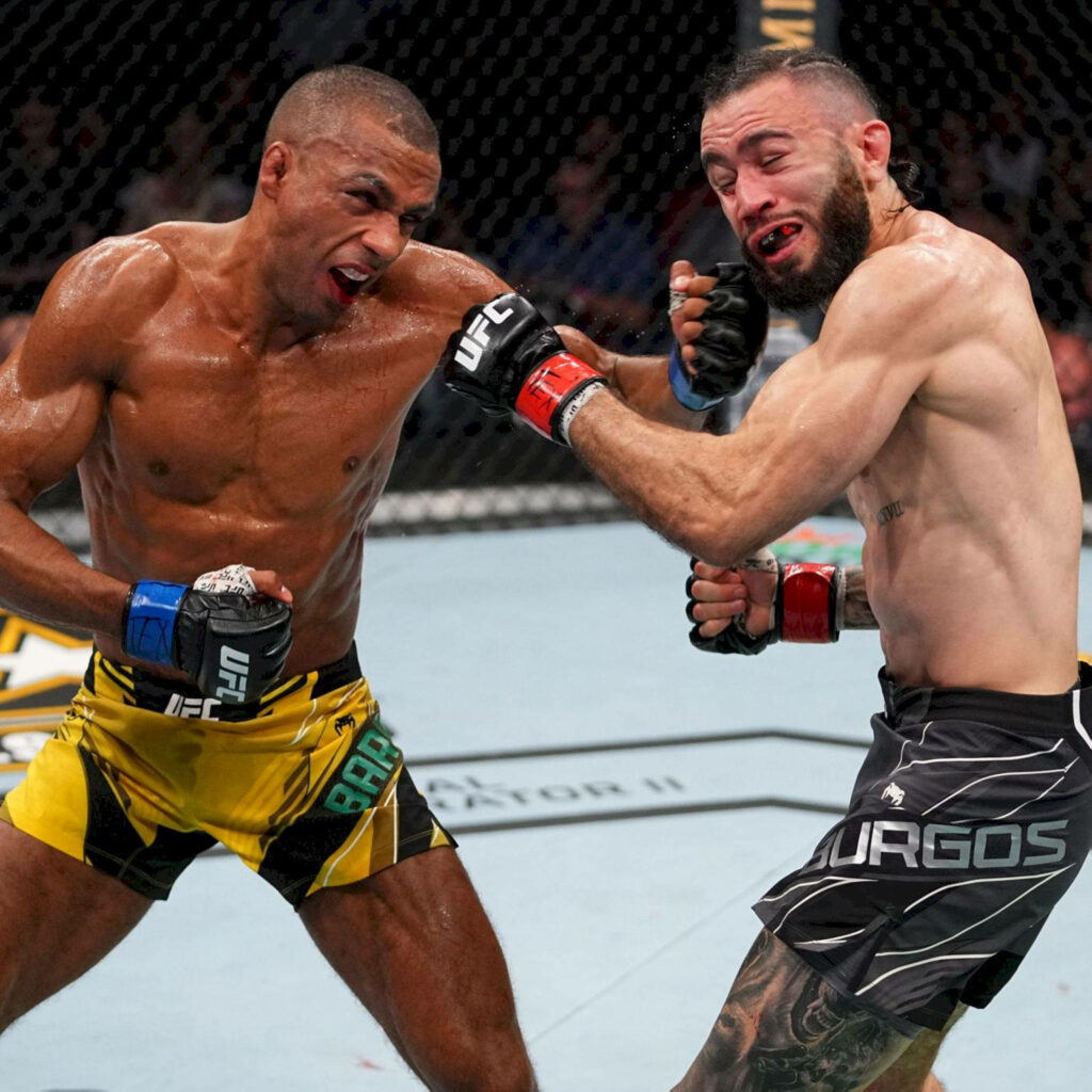 Edson Barboza lands powerful punch on Shane Burgos in intense UFC fight under bright lights Wallpaper
