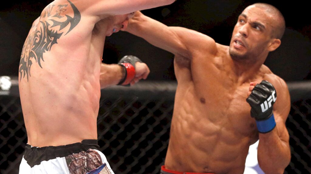 Edson Barboza lands a powerful UFC punch displaying intense focus and athleticism in octagon Wallpaper