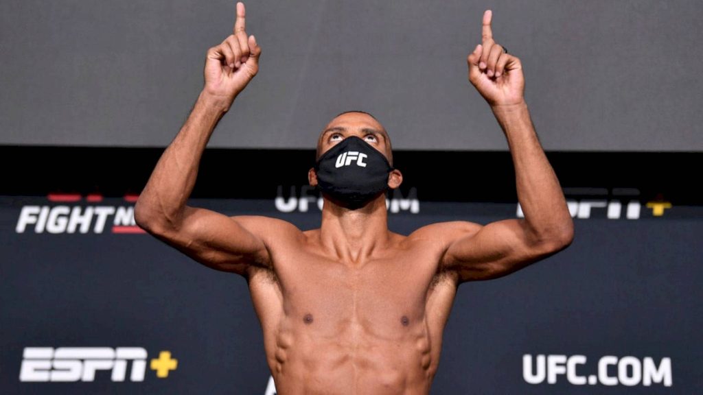 UFC fighter Edson Barboza shirtless pointing skyward wearing black UFC mask at weigh-in backdrop Wallpaper