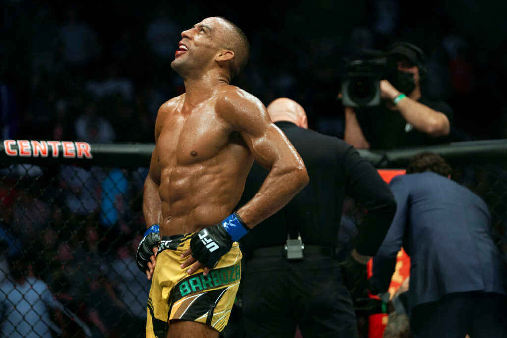 Edson Barboza inside UFC octagon muscles tensed sweat glistening intense focus triumph Wallpaper