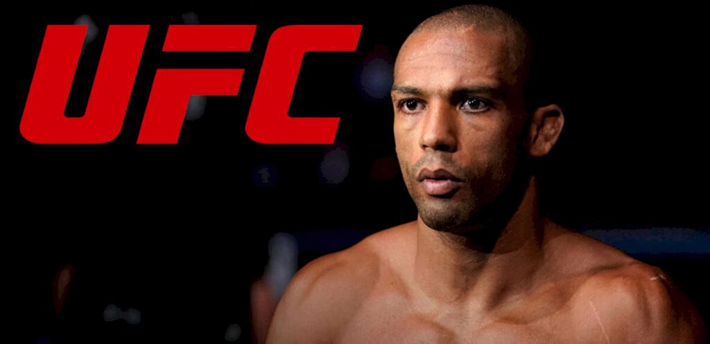 Close-up of UFC fighter Edson Barboza with intense expression and red UFC logo on dark background Wallpaper