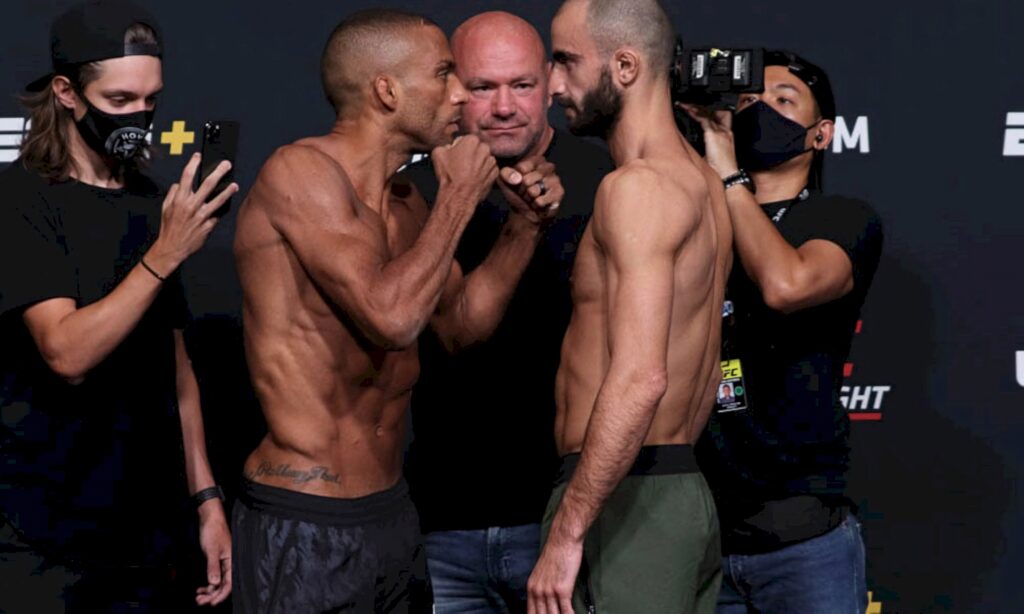 Edson Barboza and Giga Chikadze intense MMA staredown with dramatic lighting dark background wallpaper