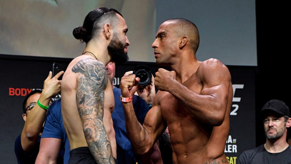 Edson Barboza and Shane Burgos intense pre-fight stare down stage bright lights athletic physiques Wallpaper
