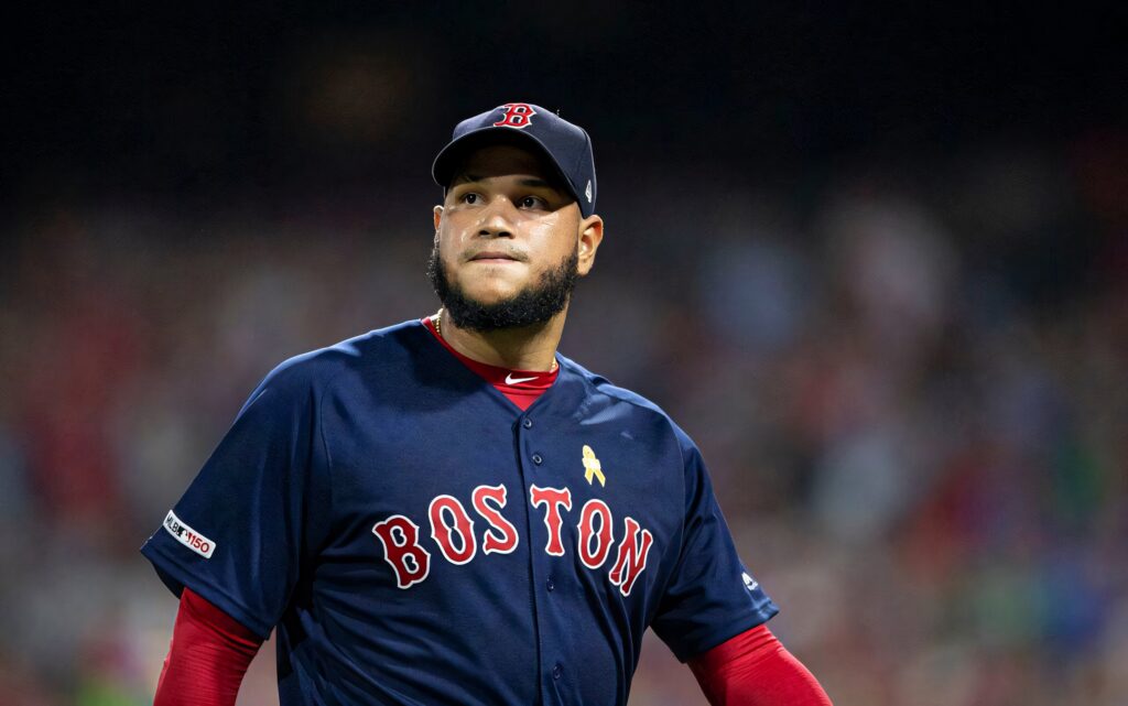 Eduardo Rodríguez pitching in Boston Red Sox uniform with stadium lights and focus Wallpaper